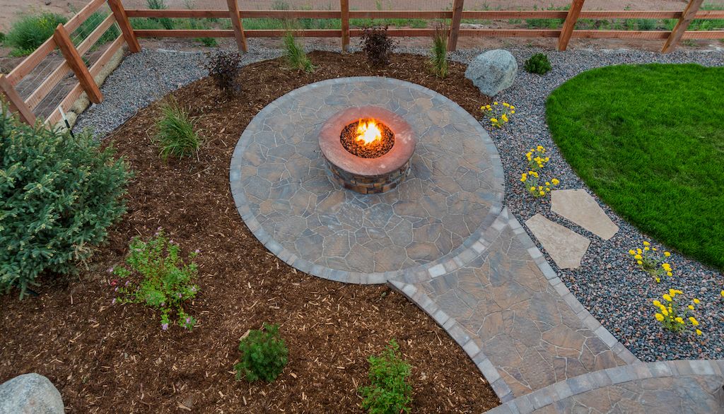 backyard fire pit on patio near mulch