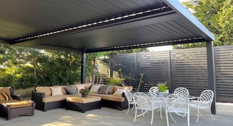 large patio with cover and seating area in backyard