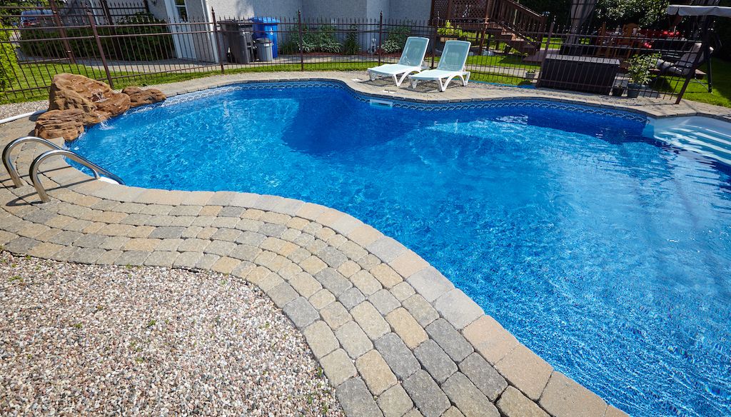 inground swimming pool in backyard