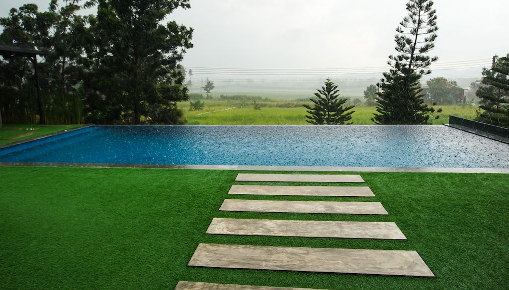 pathway in grass that leads to swimming pool