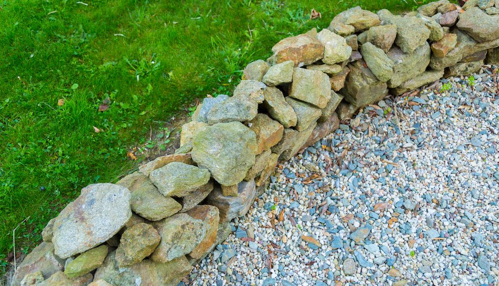 stone edging and gravel around grass