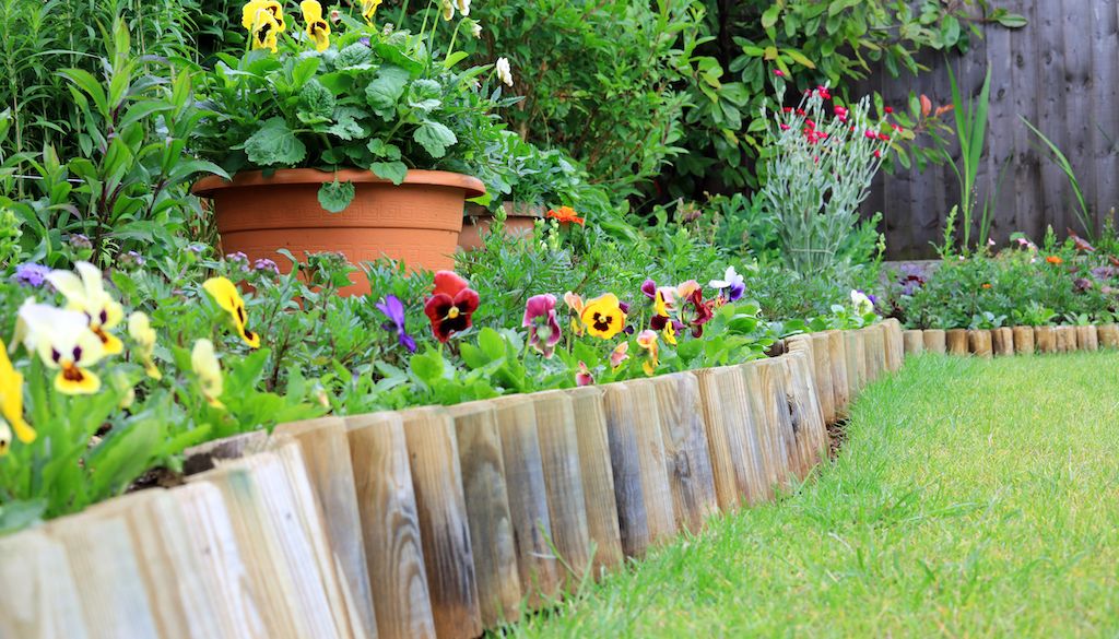 wood log edging around flower bed