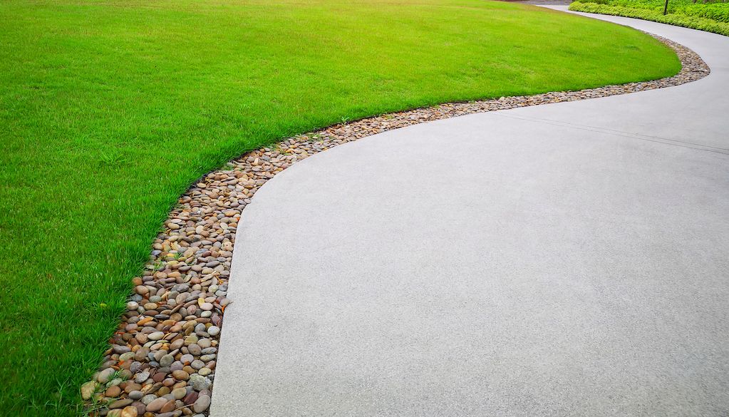 river rocks as edging near driveway