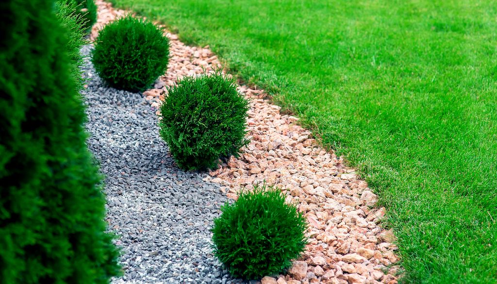 landscaping rocks and gravel to separate lawn from garden