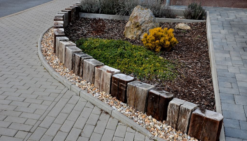 landscape edging example with wood and rocks in front yard