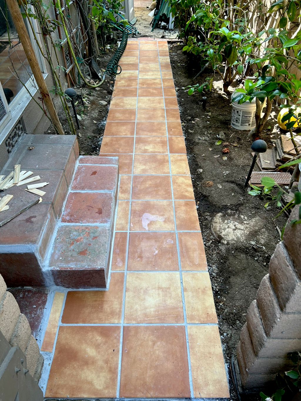 Made a concrete walkway and laid new tiles in the 
