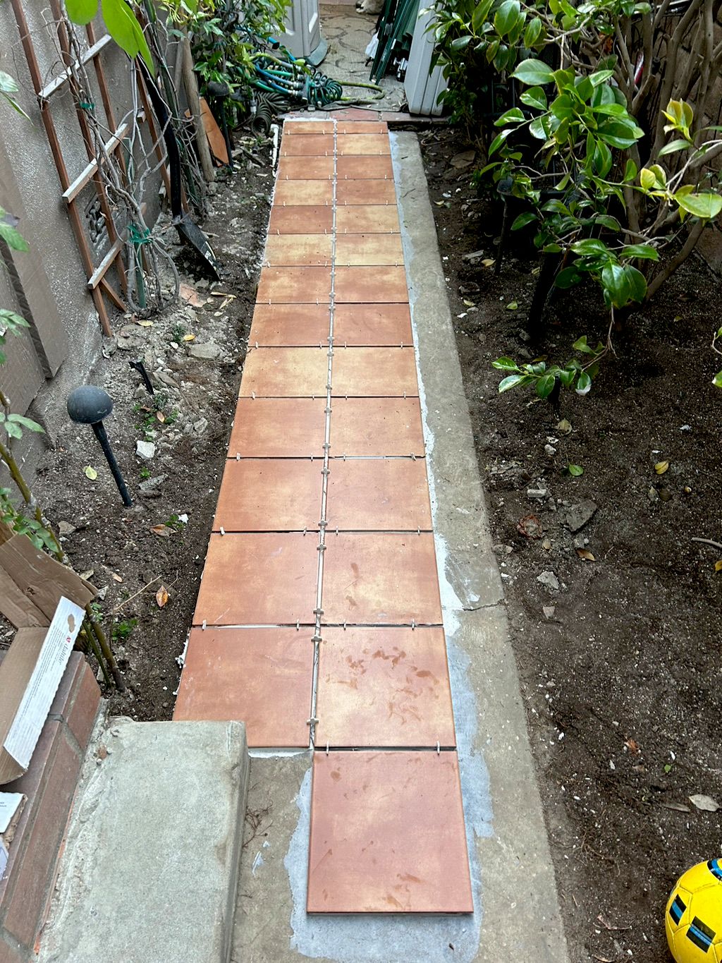 Made a concrete walkway and laid new tiles in the 