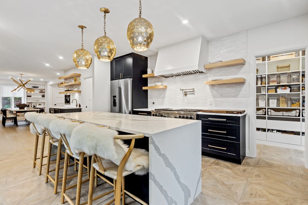 Kitchen with chandelier grey kitchen island and refrigerator