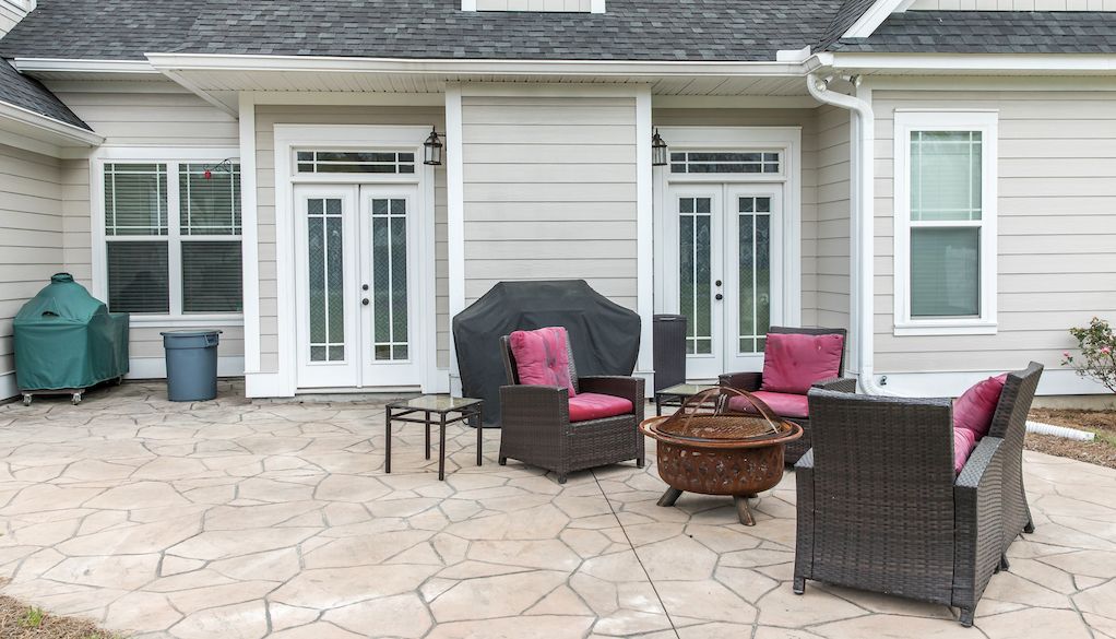 stamped concrete patio with furniture