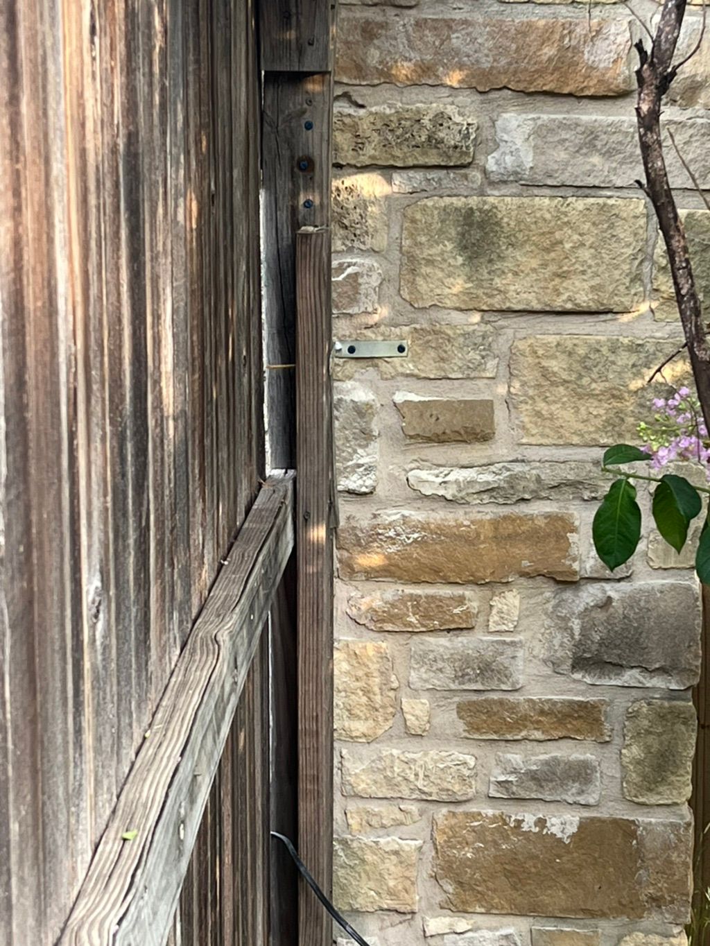 The back side of the fence secured to the stone!