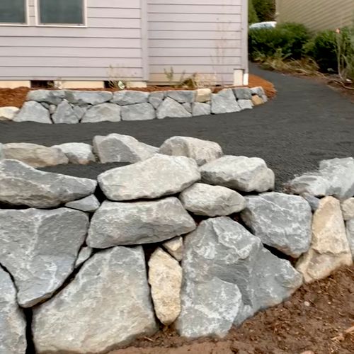 Rock retention wall with rock fire pit installatio