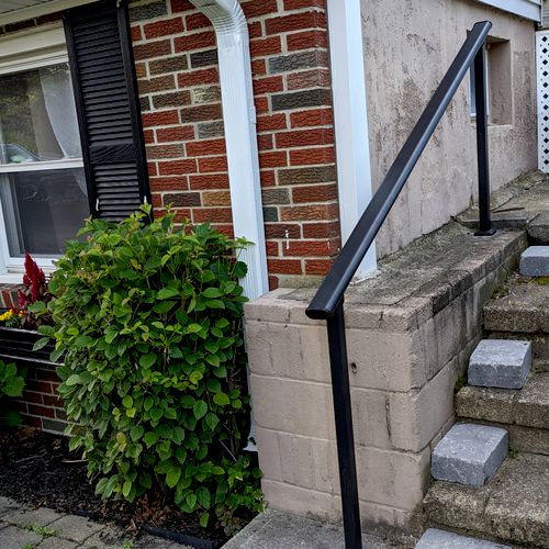 Tyler installed a handrail on cement steps outside