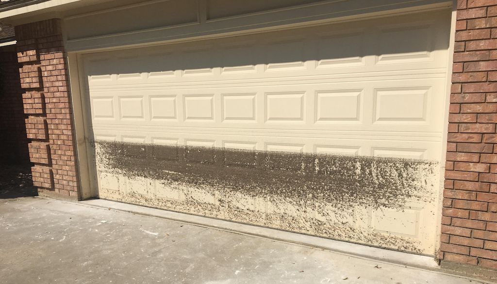 dirty water line on garage door exterior