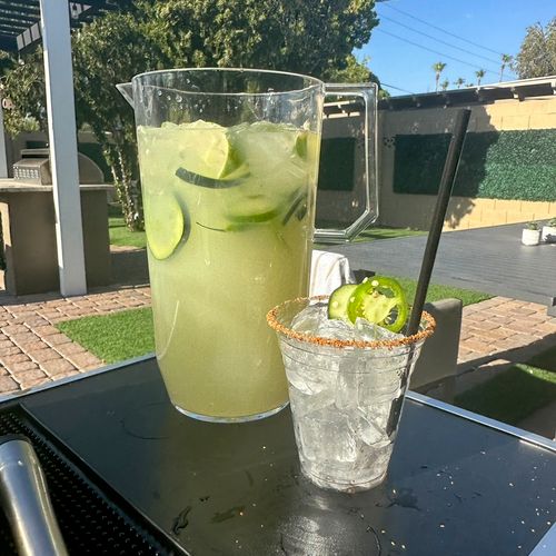 Pitcher of spicy cucumber jalapeño margarita with 