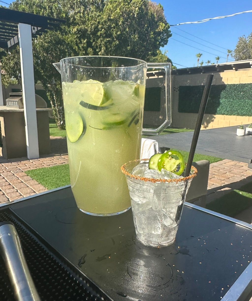 Pitcher of spicy cucumber jalapeño margarita with 