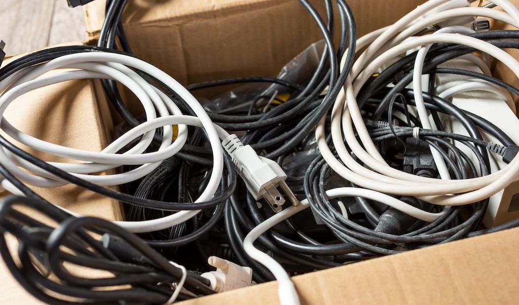 box of electric cords and cables