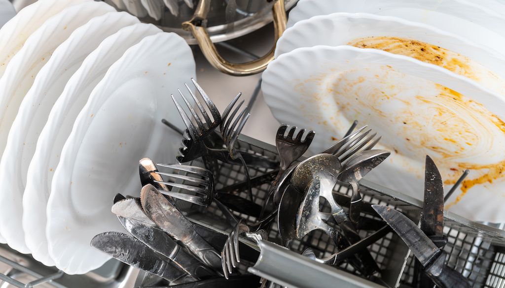 dirty dishes in dishwasher rack