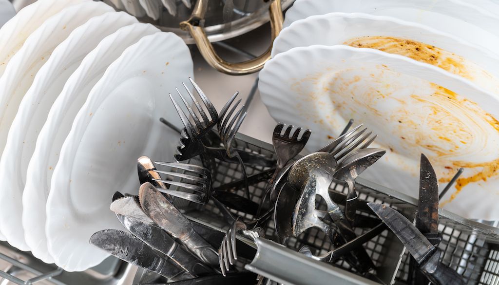 dirty dishes in dishwasher rack