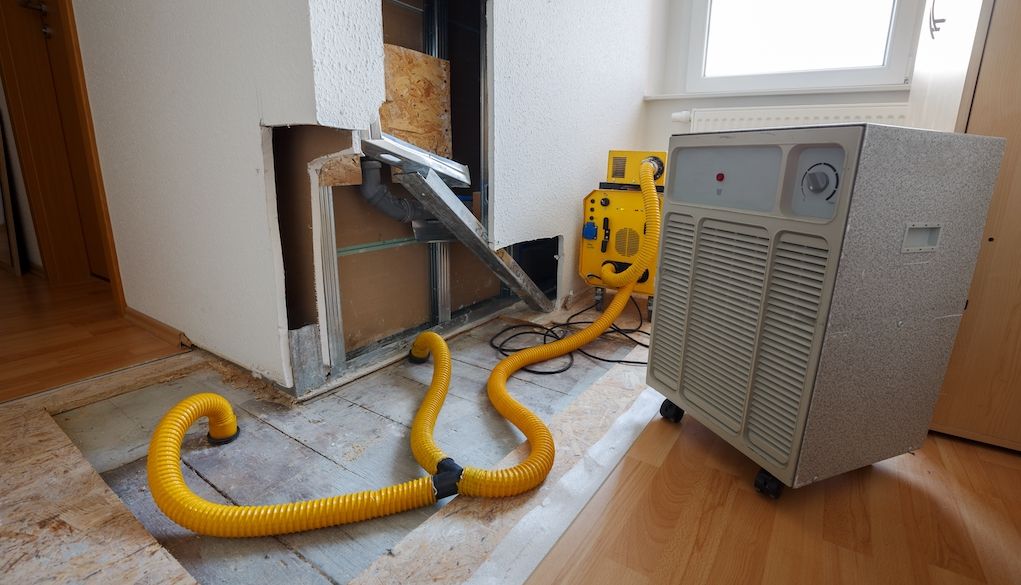 using machine to dry out home and repair water damage from flood