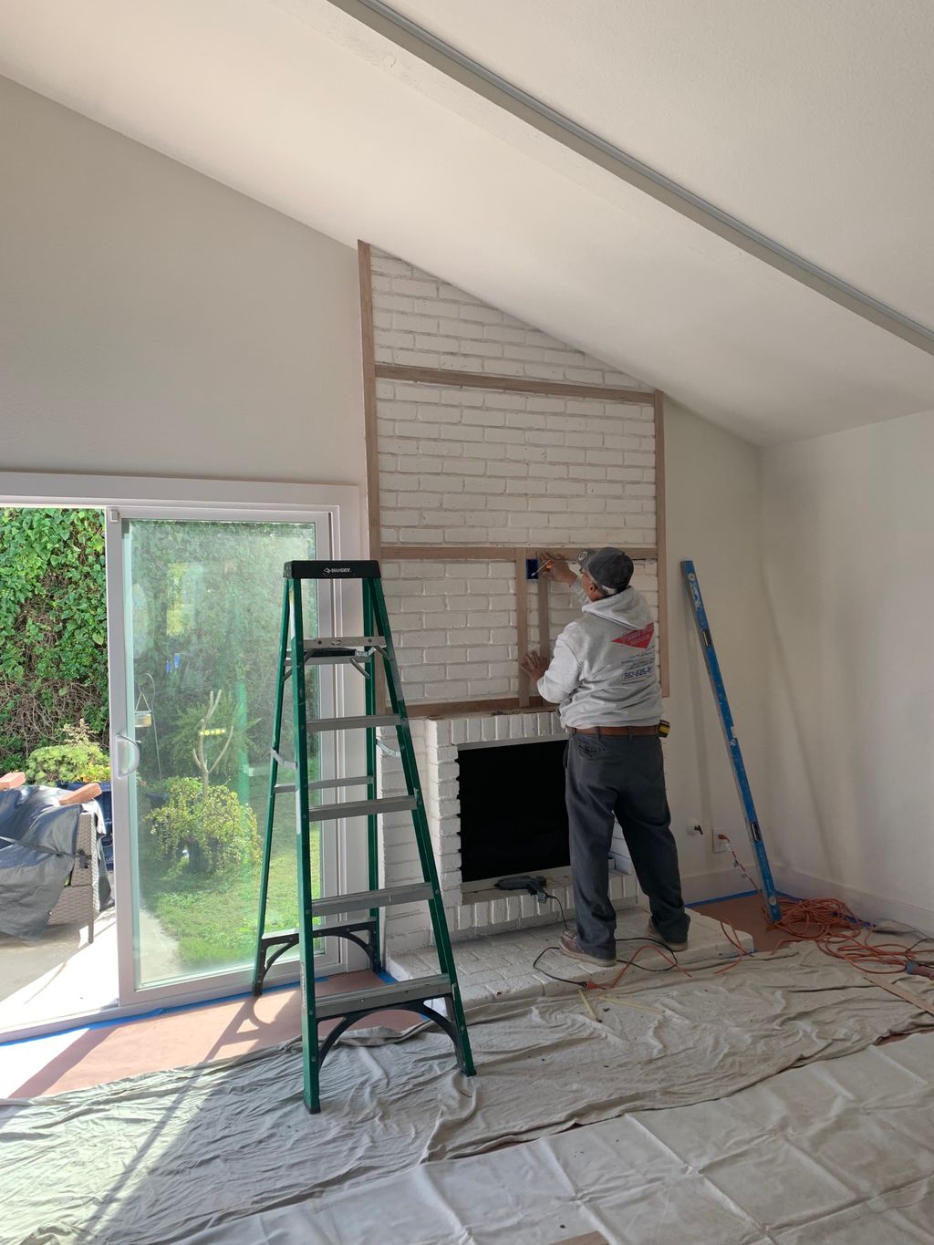 Quartz material installation above fireplace