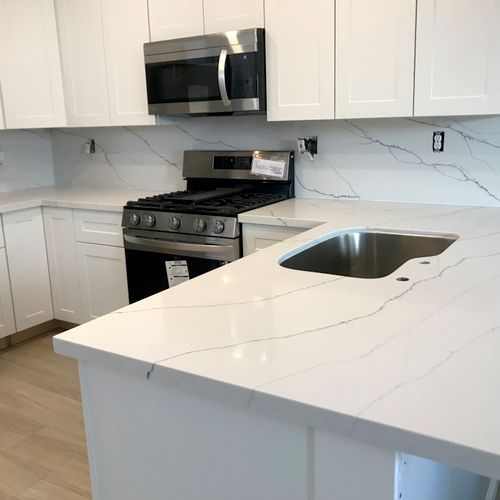 Quartz material kitchen installation with full bac