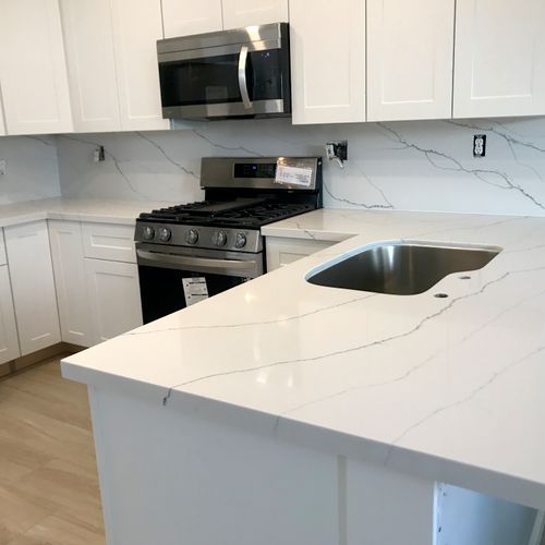 Quartz material kitchen installation with full bac