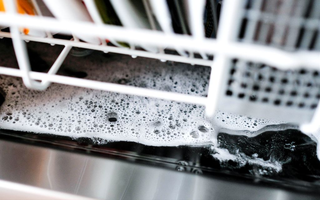 Why is there water in the bottom of my dishwasher when it's not in use?