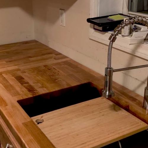 Butcher block countertop with undermount sink. 