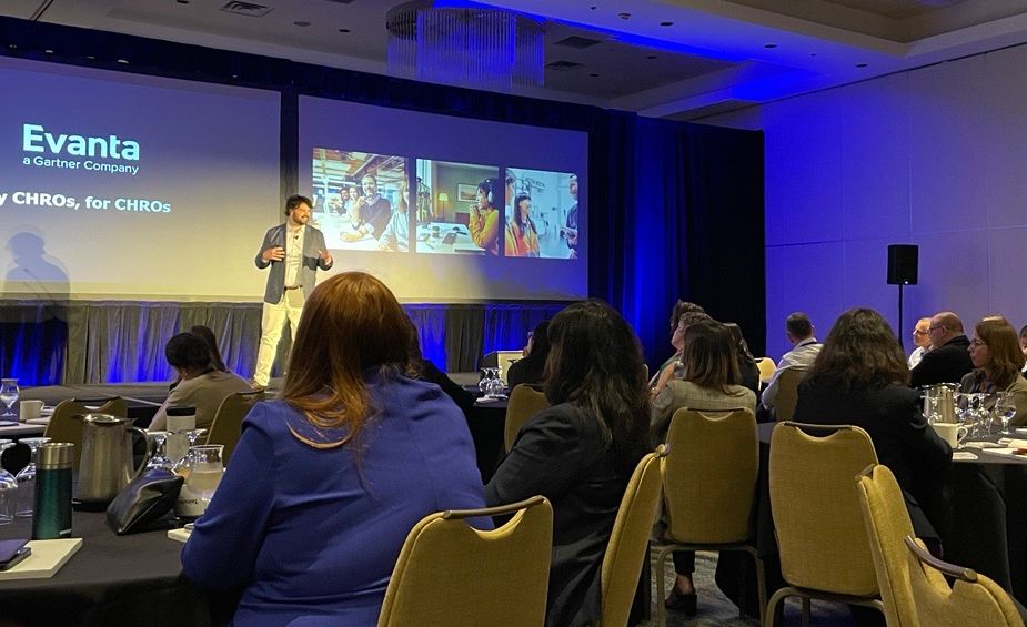 Dr. Alex speaking at an event about change, burnou