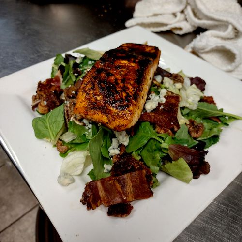 Seared salmon on a bed of spinach and watercress s