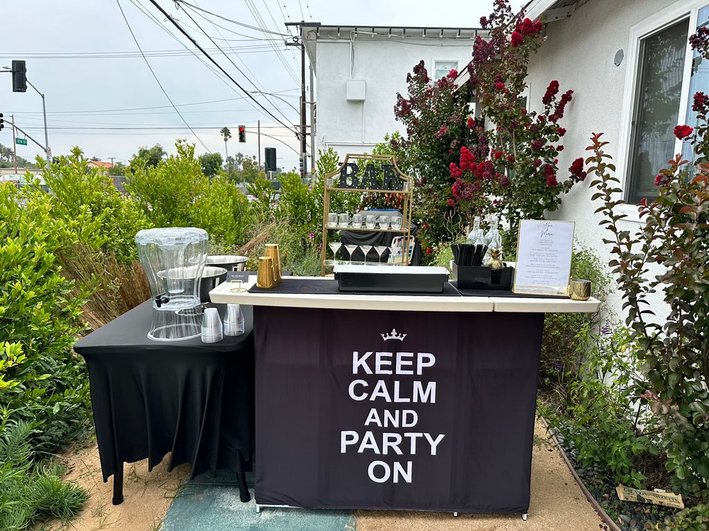 Bar setup: gold back bar, bar, cooler, water dispe