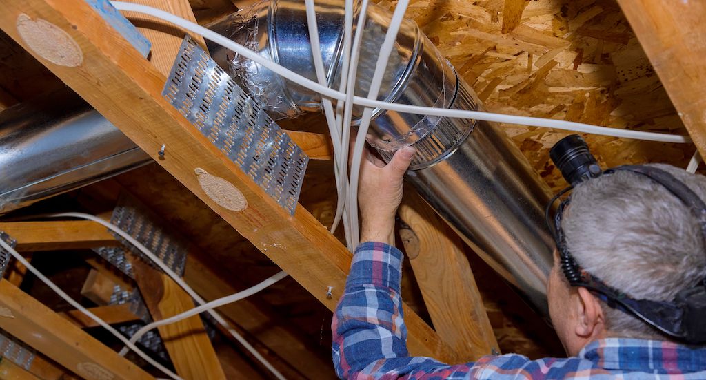professional inspect air ducts in HVAC system