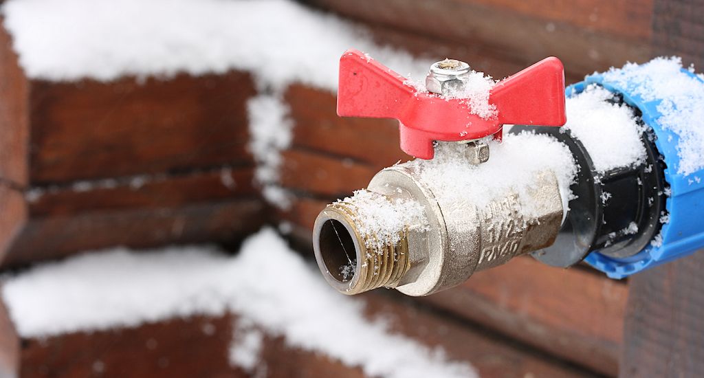 outdoor faucet with frost and ice on it