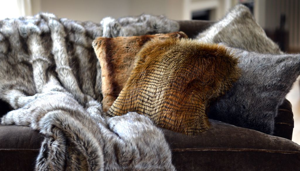 fur pillows and blankets on couch