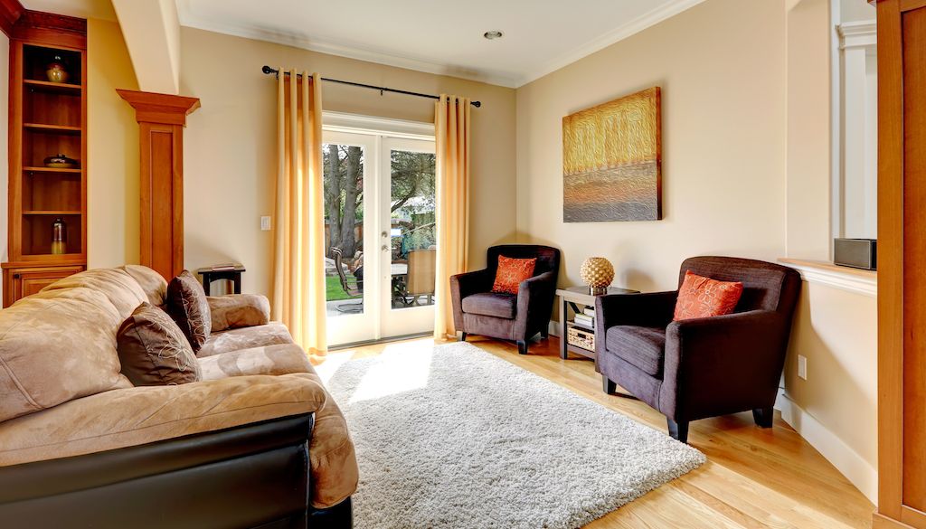 warm colored bedroom with grey fluffy rug on floor