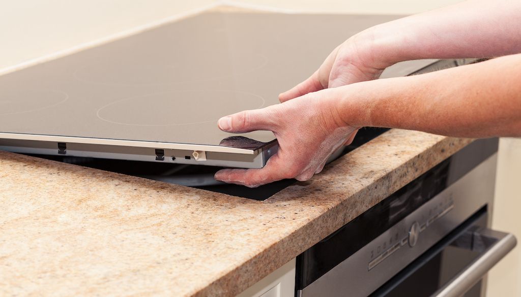 professional installing induction stove