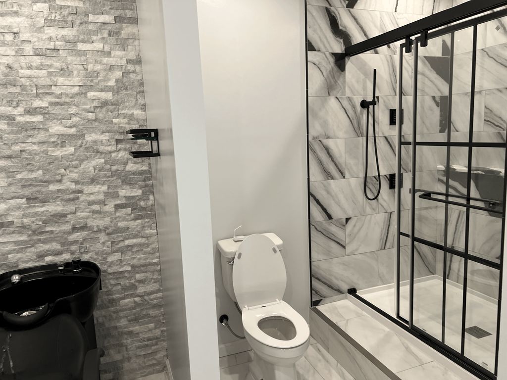 Bathroom with shampoo sink in a basement renovatio