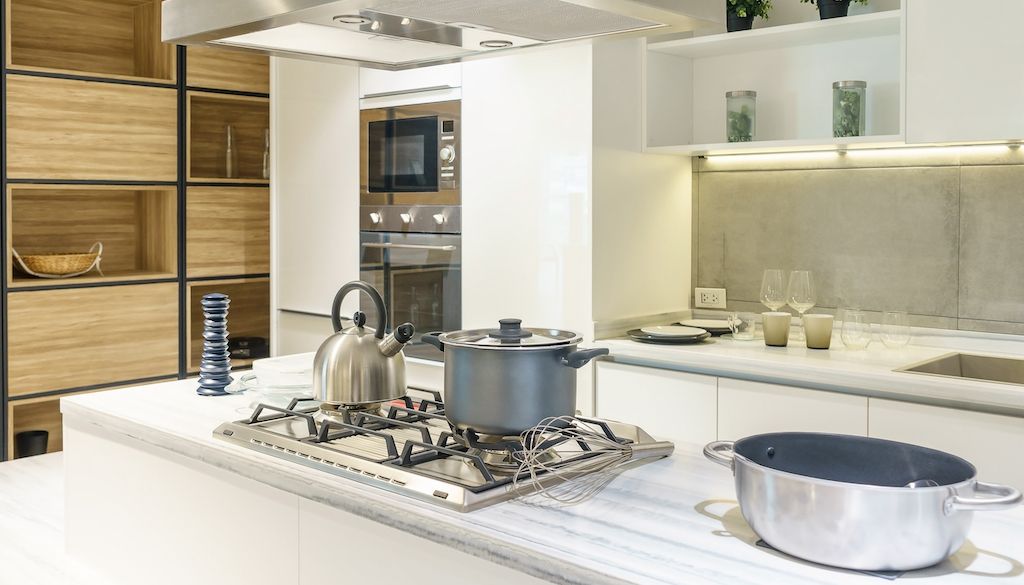 kitchen setup with wall oven and a cooktop on kitchen island