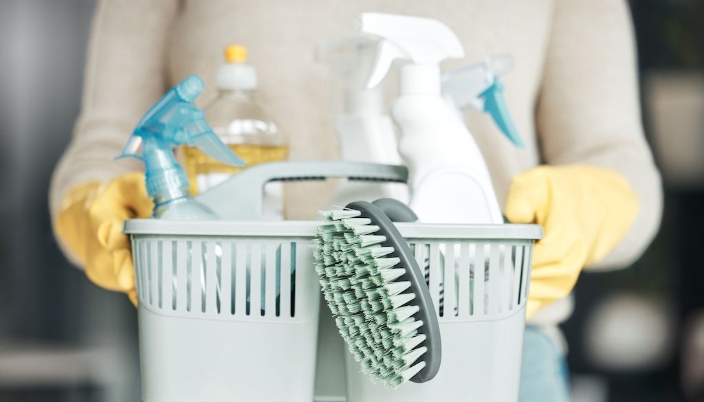 bucket of several cleaning bottles