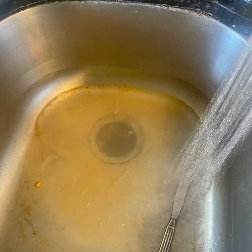 Clogged kitchen sink due to food and grease build 