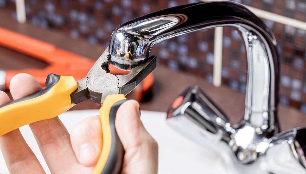 plumber repairing leaky faucets