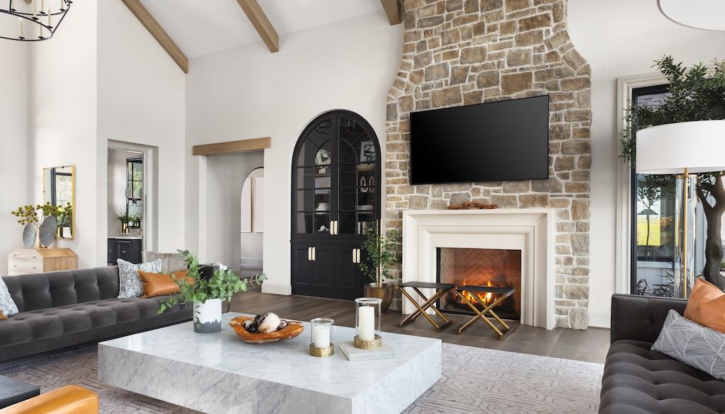 living room with stone fireplace mantle