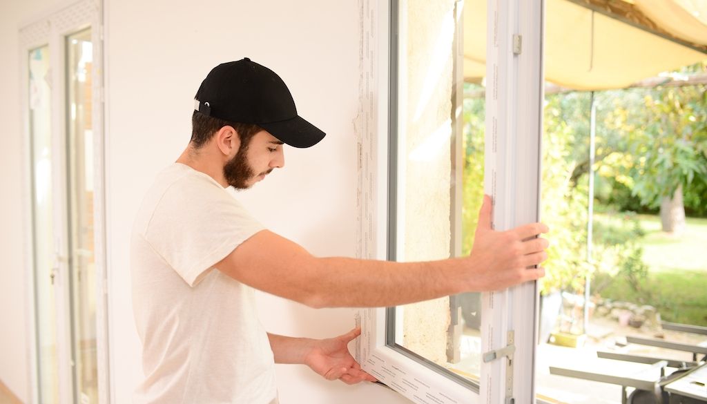 professional installing energy efficient windows in home