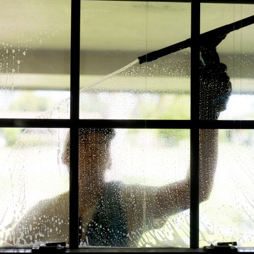 Using traditional window cleaning tools.