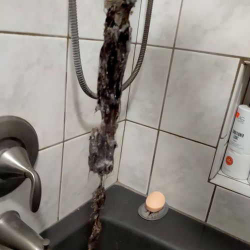 Hair removed from a bathtub line. 