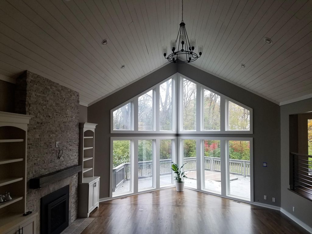 Beautiful trim and large windows and wood plank ce