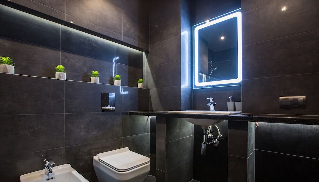 smart bathroom with large tiles and mirror