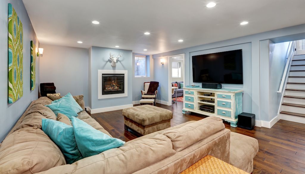 basement with blue walls and TV