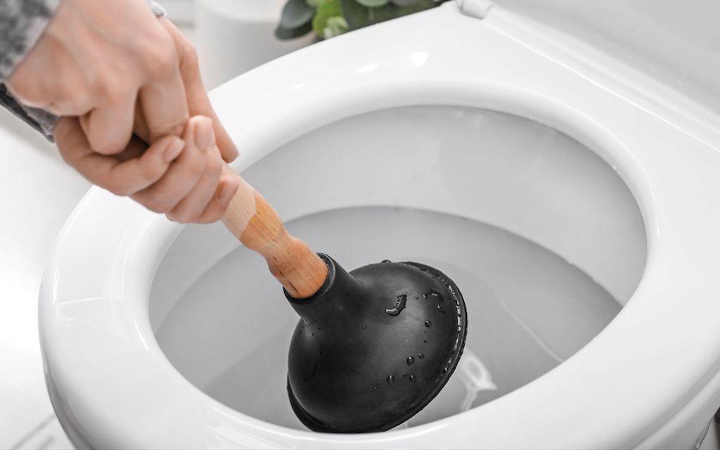 How to unclog a toilet — with or without a plunger.