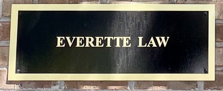Everette Law on brick street sign for building